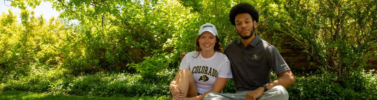 Two students outside smiling