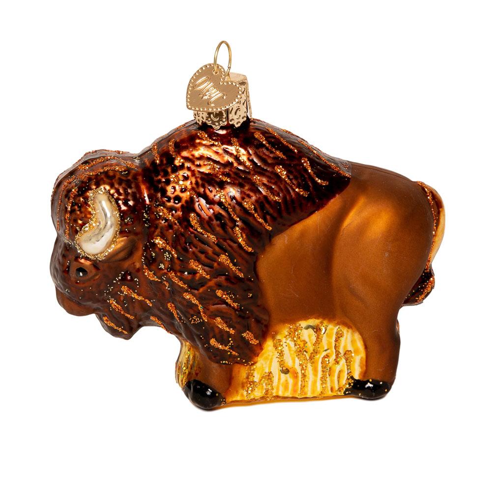 A glass brown buffalo ornament with shimmery gold detailing.