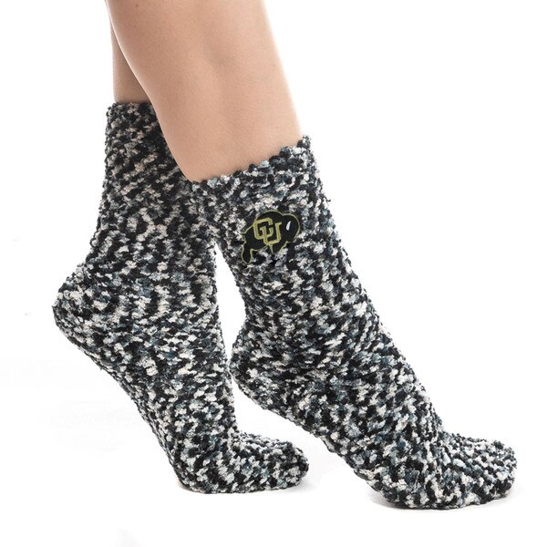 A pair of fuzzy speckled black and white socks with the CU Buffalo logo on the side of each sock.