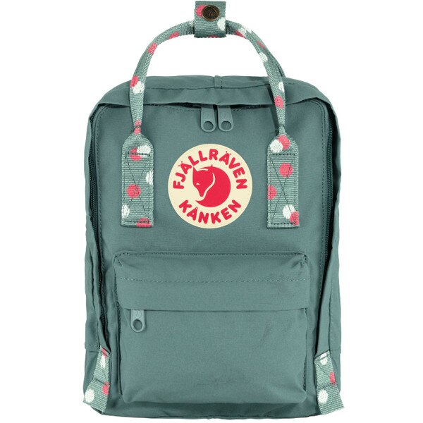 A green mini backpack with the Fjallraven Kanken logo and white and pink polka dots on the handle.