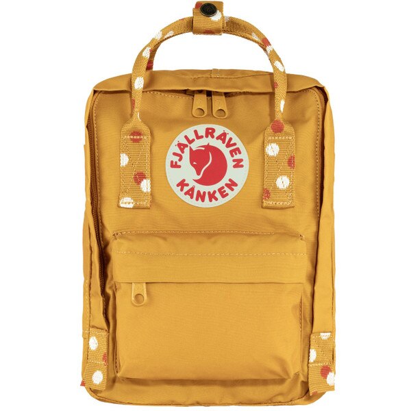 A yellow mini backpack with the Fjallraven Kanken logo and white and orange polka dots on the handle.