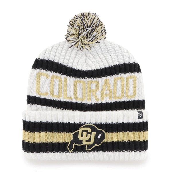 White beanie with black and Vegas Gold stripes, “COLORADO” knit in Vegas Gold across the crown, CU Buffalo logo on the cuff, and a black, white, and gold pom-pom on top.
