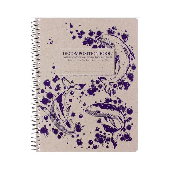 This is a Decomposition branded spiral bound composition book. The text on the cover is purple. The cover is brown with purple illustrations of humpback whales as well as decorative purple bubbles.
