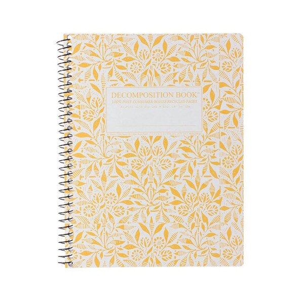 This is a spiral bound composition book. The text on the cover is gold. The cover is white with abstract golden drawings of wheat and grain.