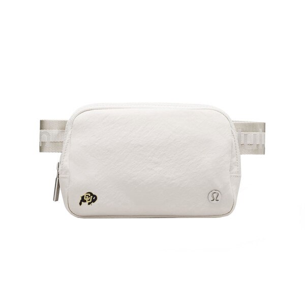 A white belt bag with a C-U buffalo logo on bottom left and a metal lululemon logo on the bottom right.