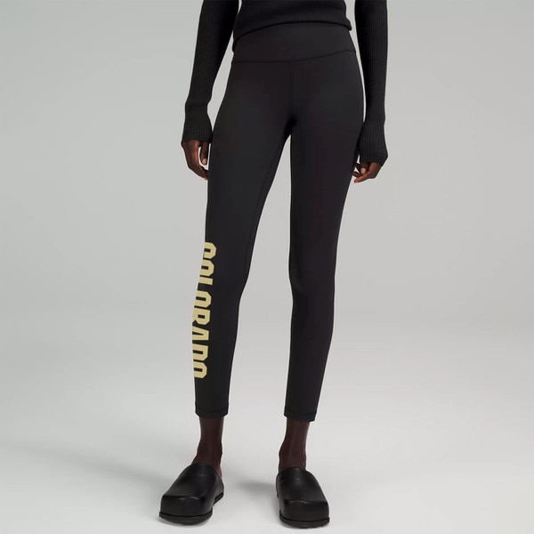 A pair of black leggings with Colorado in bold lettering alongside the outer calf.