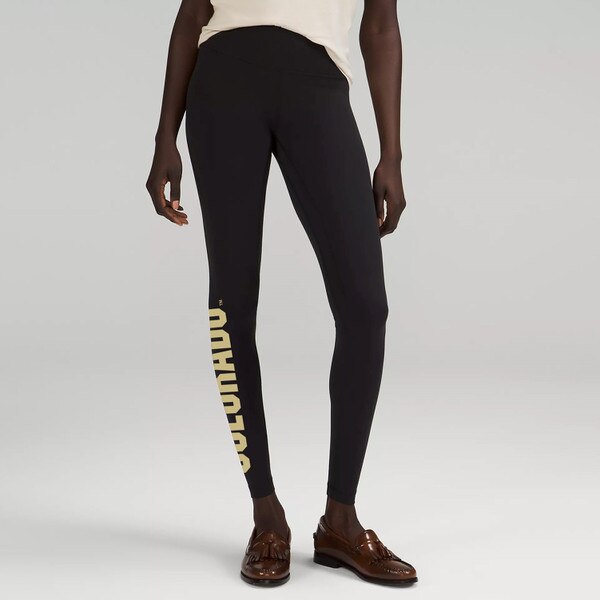 A pair of black leggings with Colorado in bold lettering alongside the outer calf.