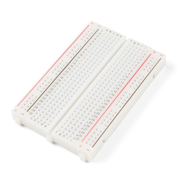 A white breadboard with letters and numbers for circuits.