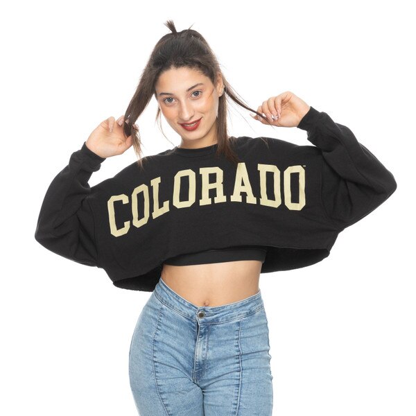Black cropped sweatshirt with 'Colorado' in bold gold lettering across the chest, worn by a model with jeans.