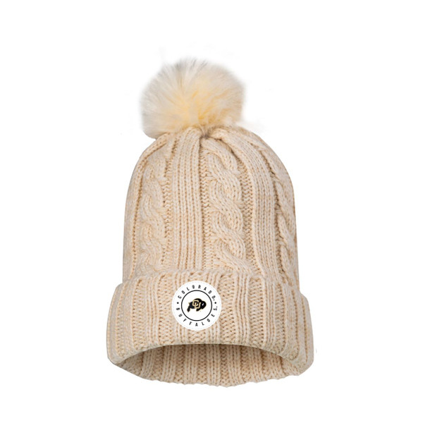 A cream cable knit beanie with a fuzzy pom on top, adorned with a white circle Colorado Buffaloes patch with the C-U Buffalo logo on the front.