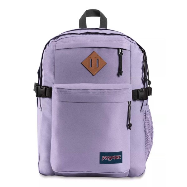 A lilac jansport backpack with two front pockets and two main compartments, with side mesh pockets, shoulder straps, and a top strap to hold.