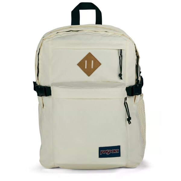 A white jansport backpack with two front pockets and two main compartments, with side mesh pockets, shoulder straps, and a top strap to hold.