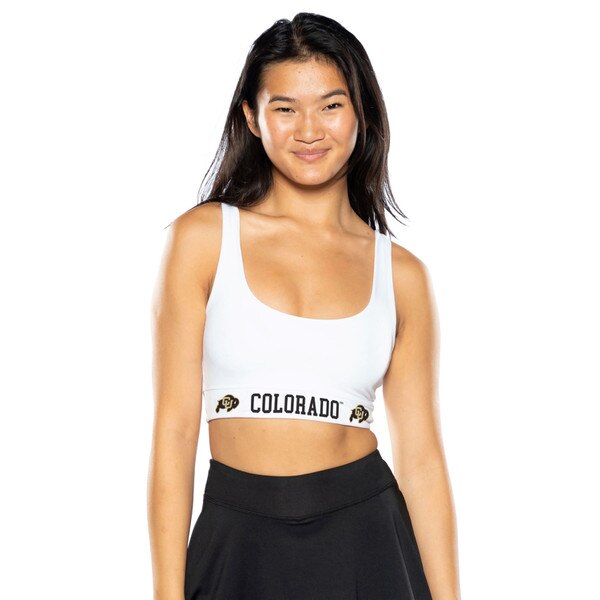 A white sports bra that says "COLORADO" in bold black print on the band. There is a CU Buffalo logo on both sides of the writing.
