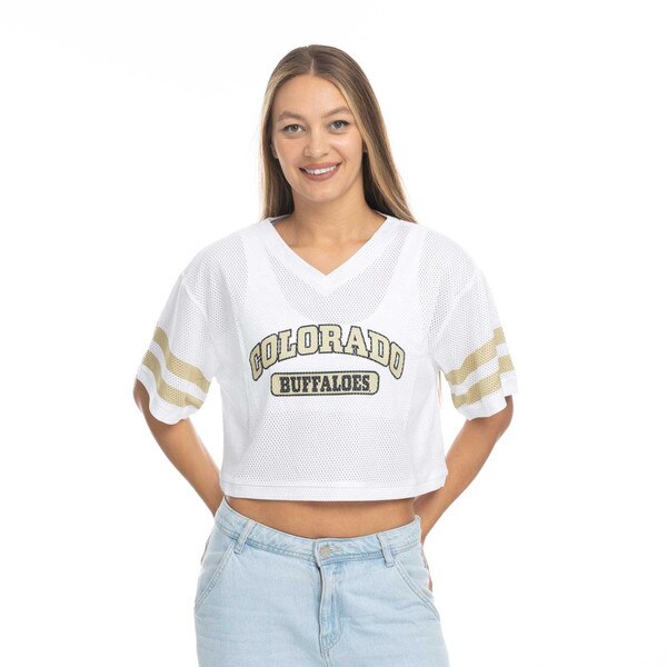 This is a white mesh crop top. Colorado is arched in Vegas gold over a white and gold Buffaloes tag logo. There are two Gold lines encircling each sleeve.