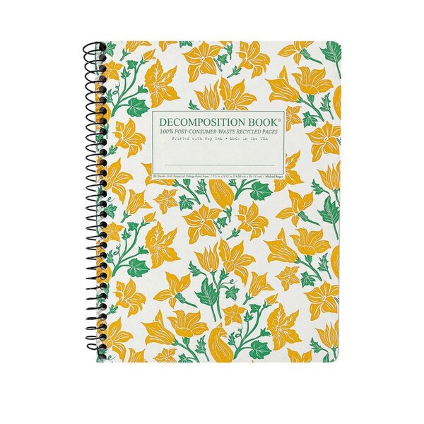 This is a Decomposition branded spiral bound composition book. The text on the cover is green. The cover has yellow squash blossoms with bright green stems.