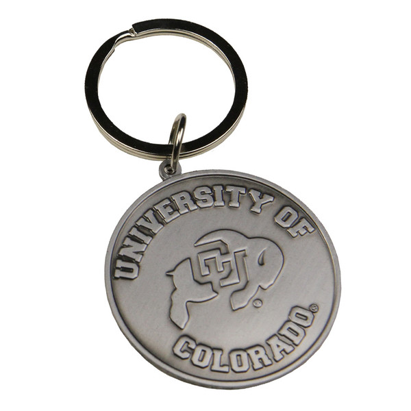 A circular metal keychain, featuring a C-U buffalo logo in the center with an attached keyring, and "University of Colorado" in rounded lettering.