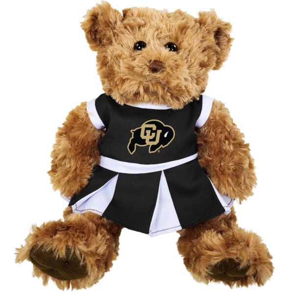 This bear has golden brown fur, black eyes, and a brown nose. The cheer uniform is black and white with a pleated skirt.