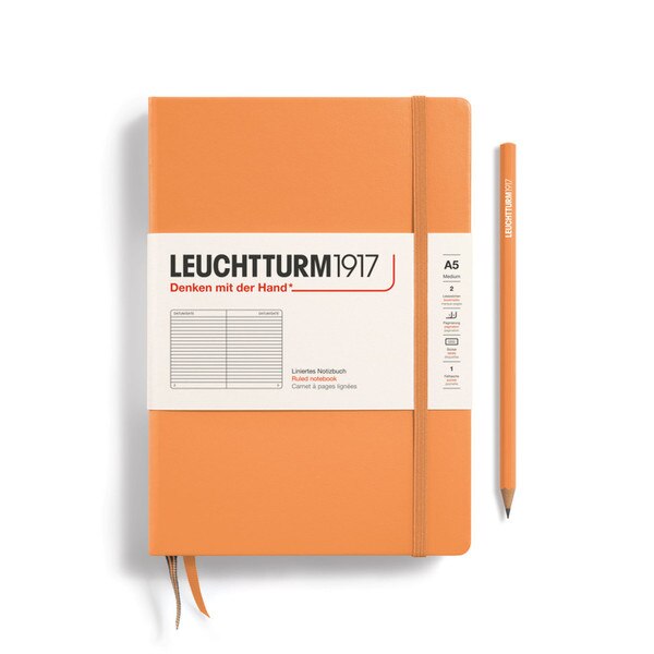 An apricot colored hardcover notebook.