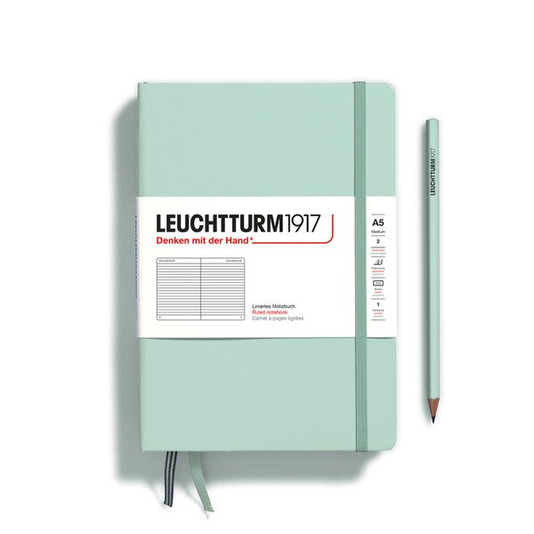 A mint colored hardcover notebook.