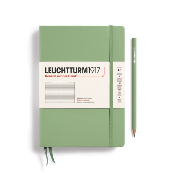 A sage colored hardcover notebook.