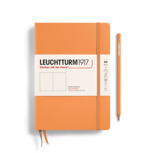 An apricot colored hardcover notebook.