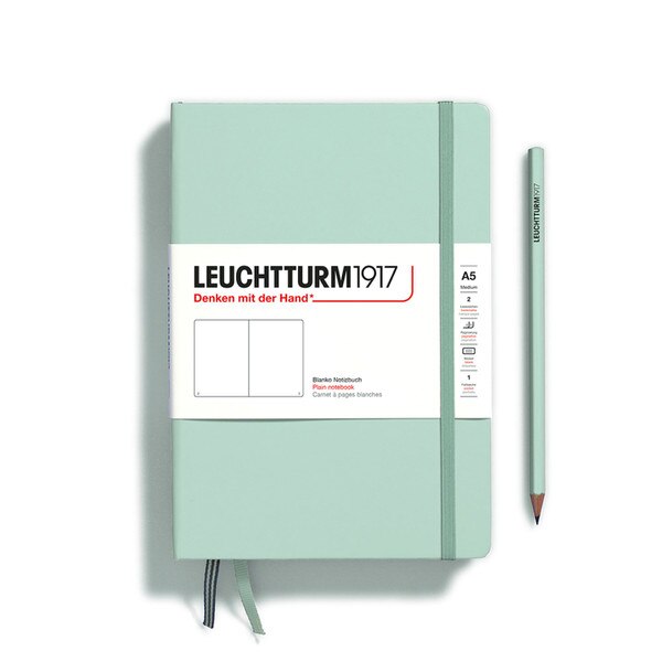 A mint colored hardcover notebook.
