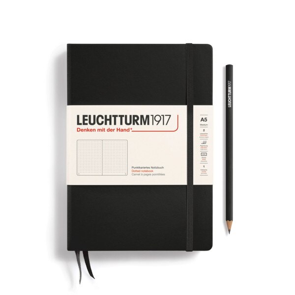Black hardcover dotted notebook with closure strap and two bookmarks.