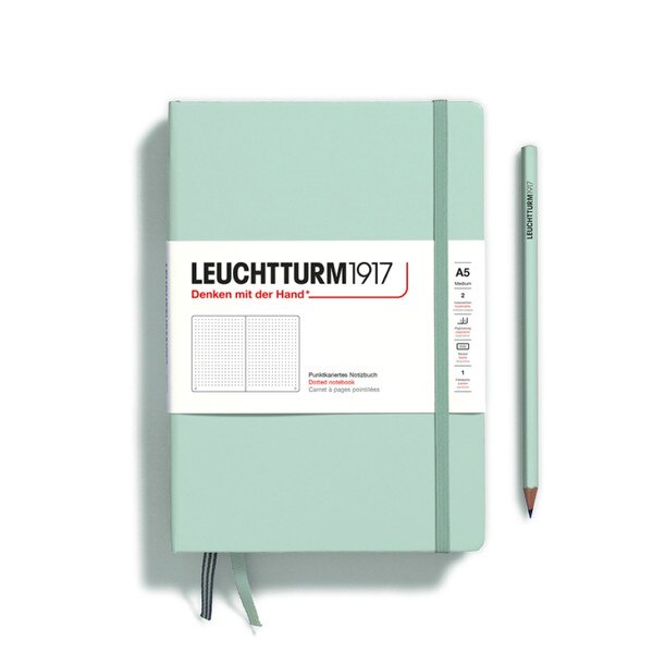 Mint hardcover dotted notebook with closure strap and two bookmarks.