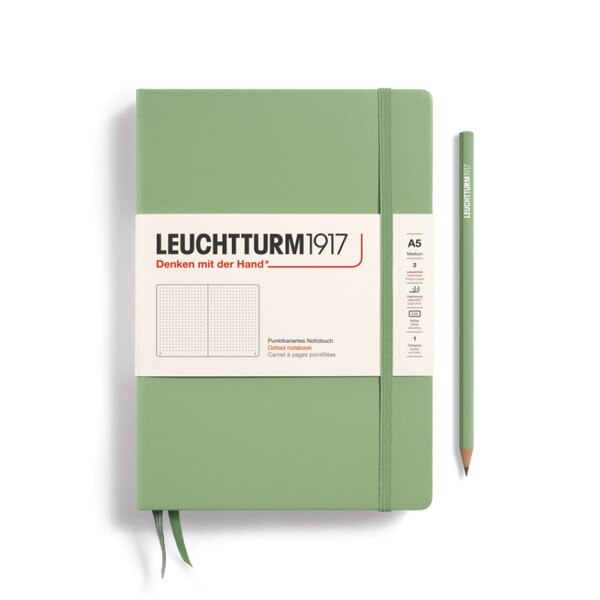 Sage green hardcover dotted notebook with closure strap and two bookmarks.