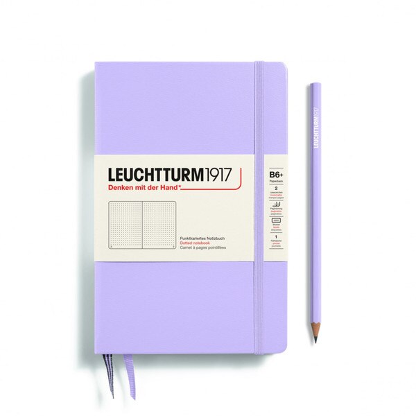A lilac notebook with an elastic to keep it closed.