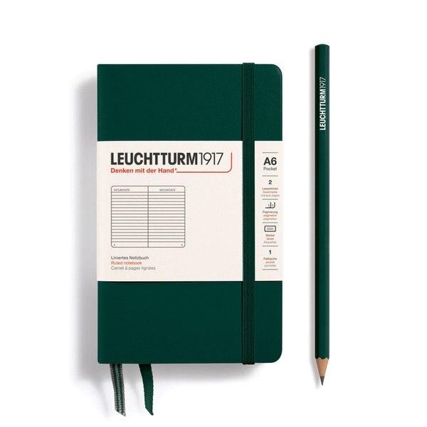 A forest colored hardcover notebook with an elastic to keep it closed.