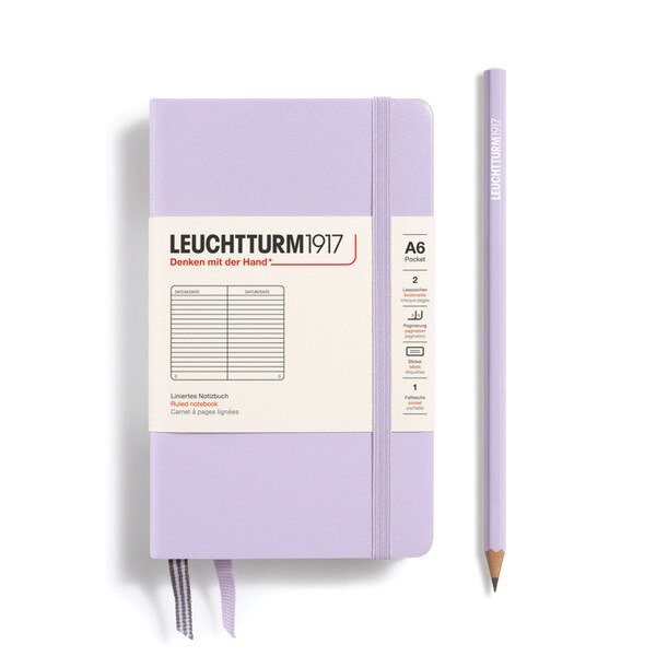 A lilac hardcover notebook with an elastic to keep it closed.