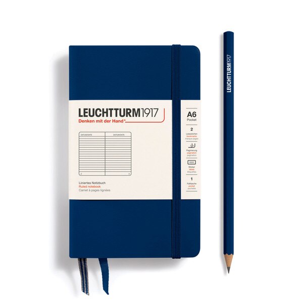 A navy hardcover notebook with an elastic to keep it closed.