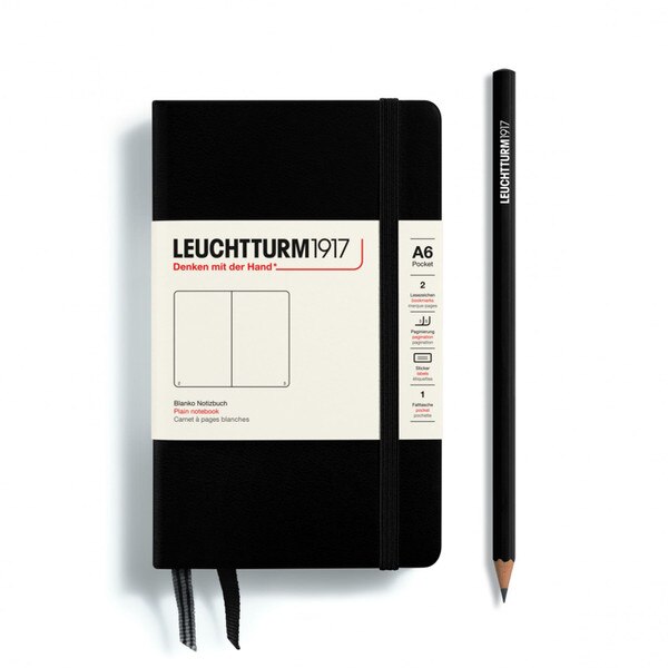 This is a small, black notebook with an elastic and two bookmarks. The pages are blank other than page numbers in the bottom corners.