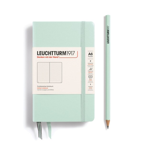 A small, mint notebook with an elastic.
