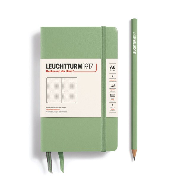 A small, sage notebook with an elastic.