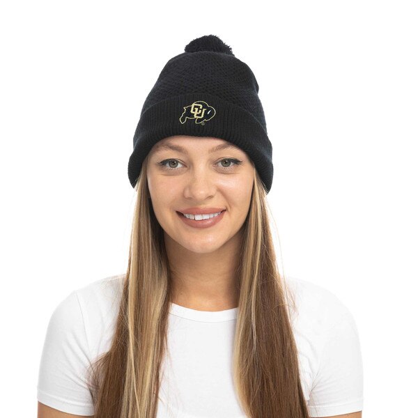 Front view of black CU Boulder waffle-knit beanie with embroidered gold logo and pom detail, shown on a person wearing a white shirt