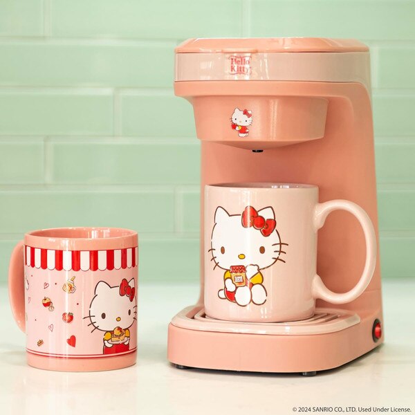 Pink Hello Kitty coffee maker with matching mugs, featuring an adorable Hello Kitty design on a kitchen counter