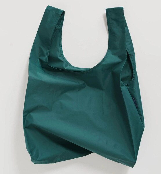 Dark teal reusable BAGGU bag with solid color design and blue logo tag