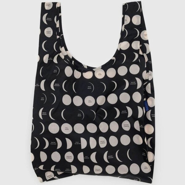 Black reusable BAGGU bag with allover white moon phases print and blue logo tag