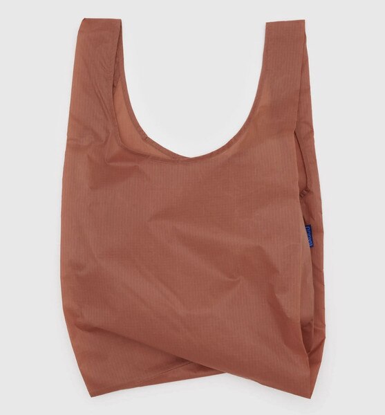 Rust-colored reusable BAGGU bag with solid design and blue logo tag