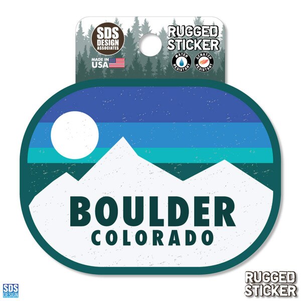 Boulder Colorado rugged sticker featuring white mountain peaks with a layered blue and teal sky and a white sun in the background.